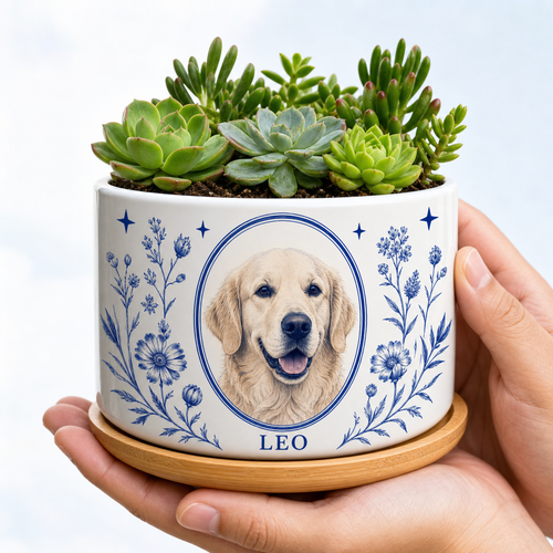 White ceramic personalized pet portrait planter with cobalt botanical artwork, golden retriever portrait, sample name LEO and green succulents