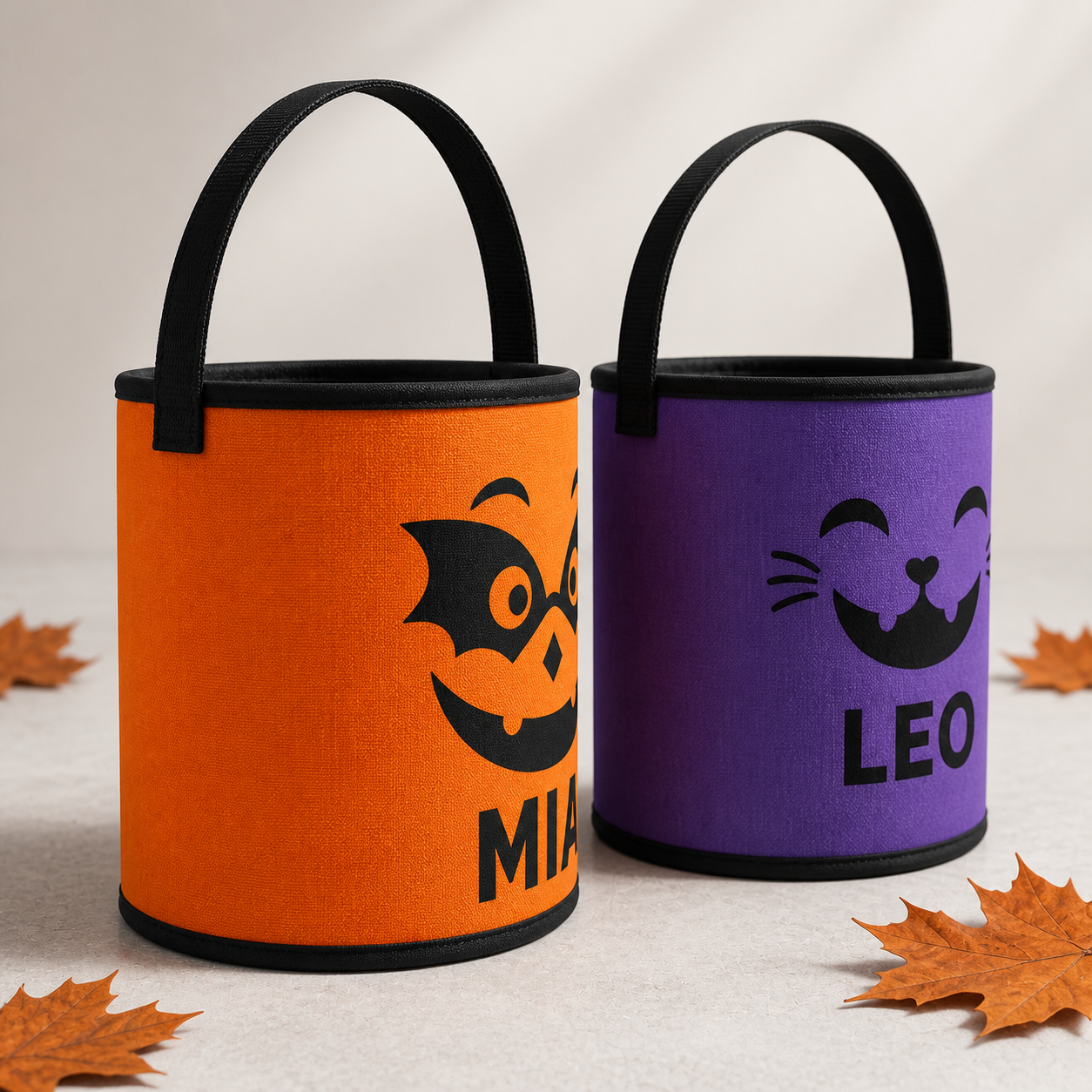 Side profile of orange MIA and purple LEO personalized Halloween treat baskets