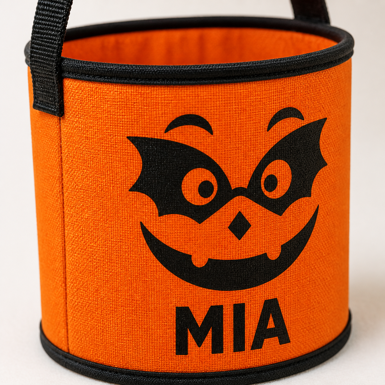 Close-up of orange MIA bat pumpkin treat basket personalization and exterior print